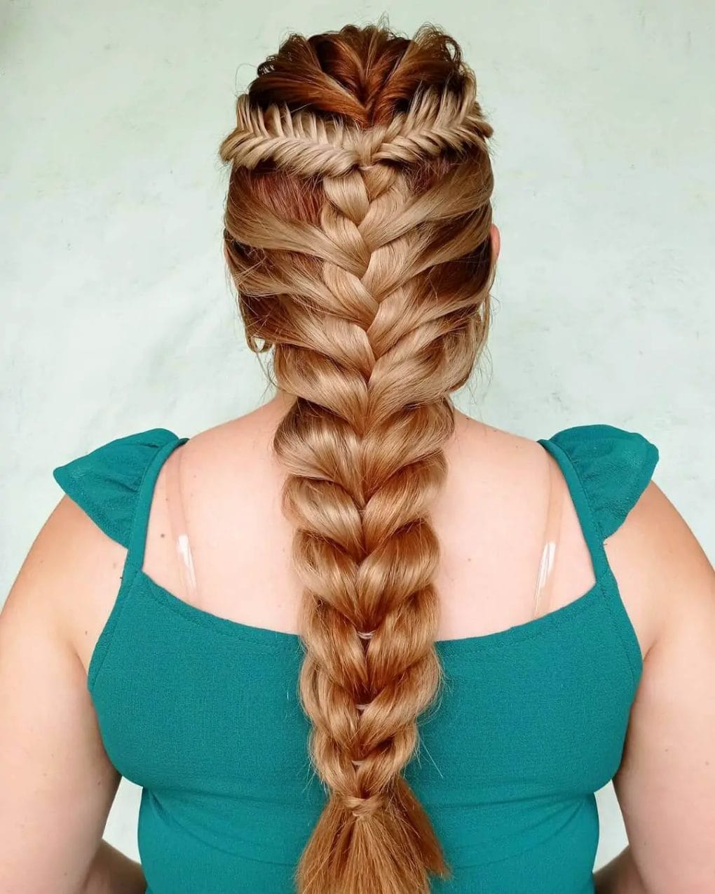 Intricate combination of fishtail, French, and pull-through braid in chestnut with golden highlights.