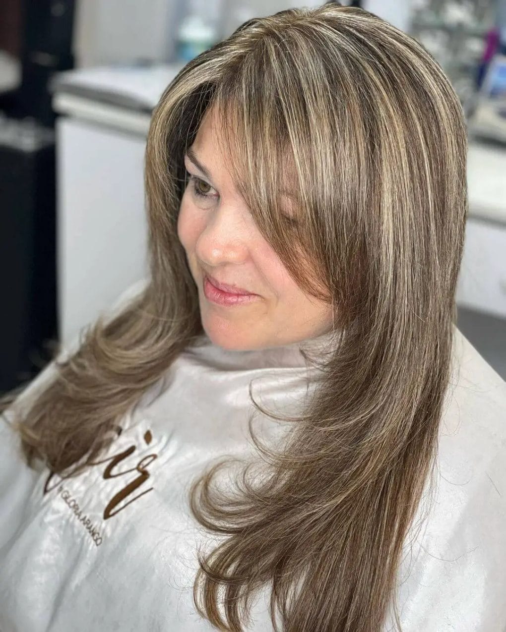 Long layers with curved ends and dimensional highlights for a flattering style.
