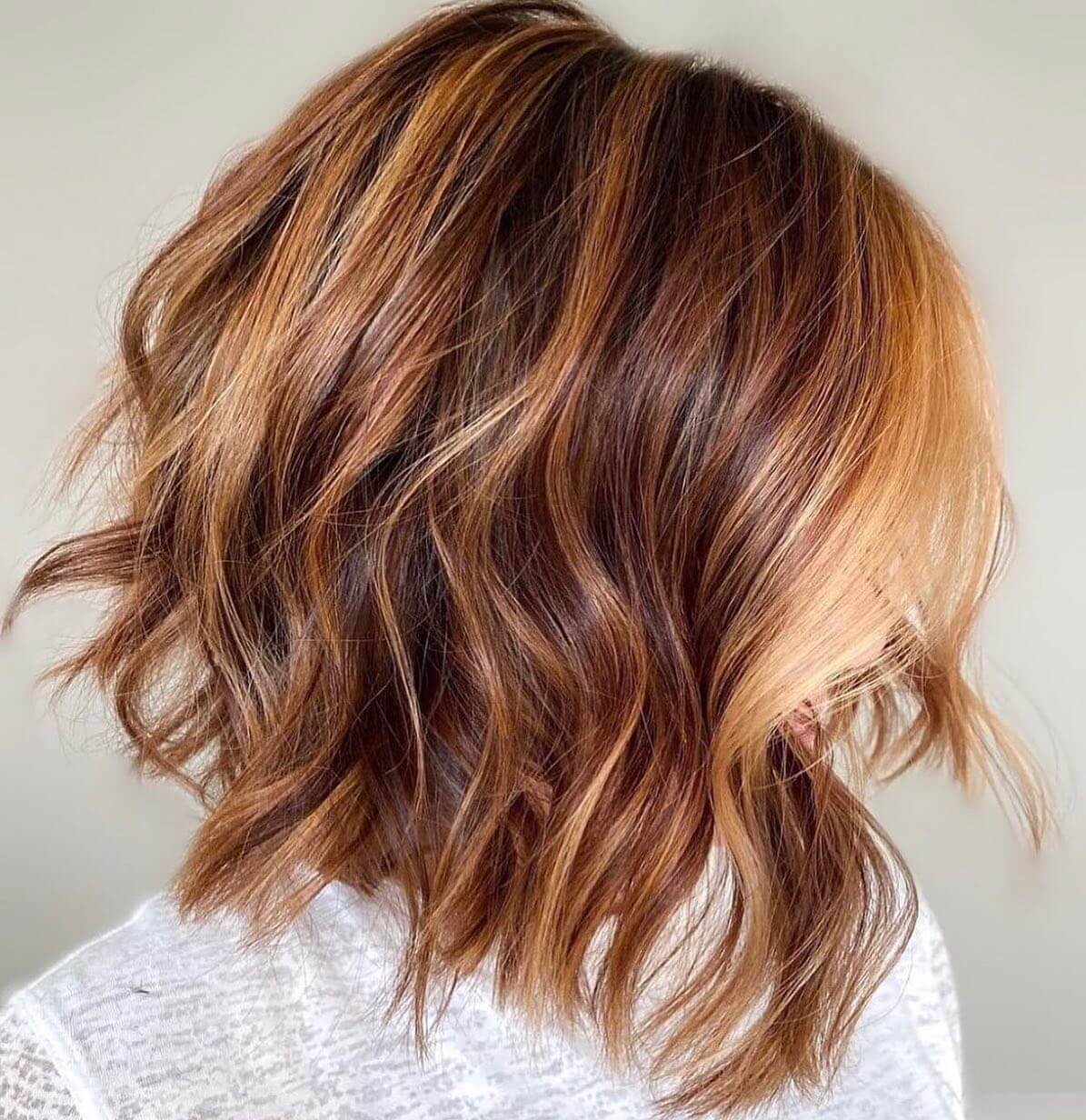 Layered bob, free-flowing with rich caramel balayage.