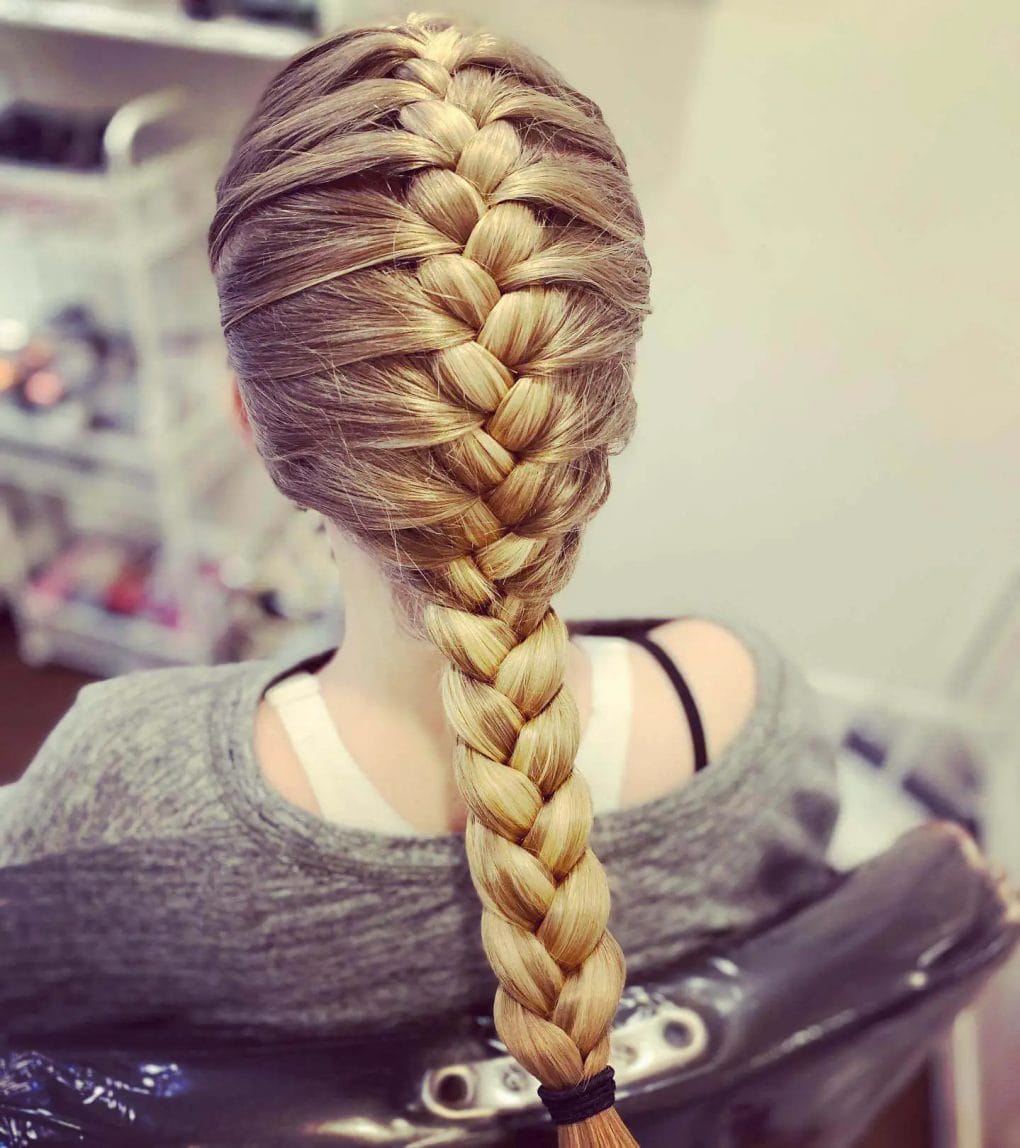 A neatly woven golden-brown French braid cascading down the back.