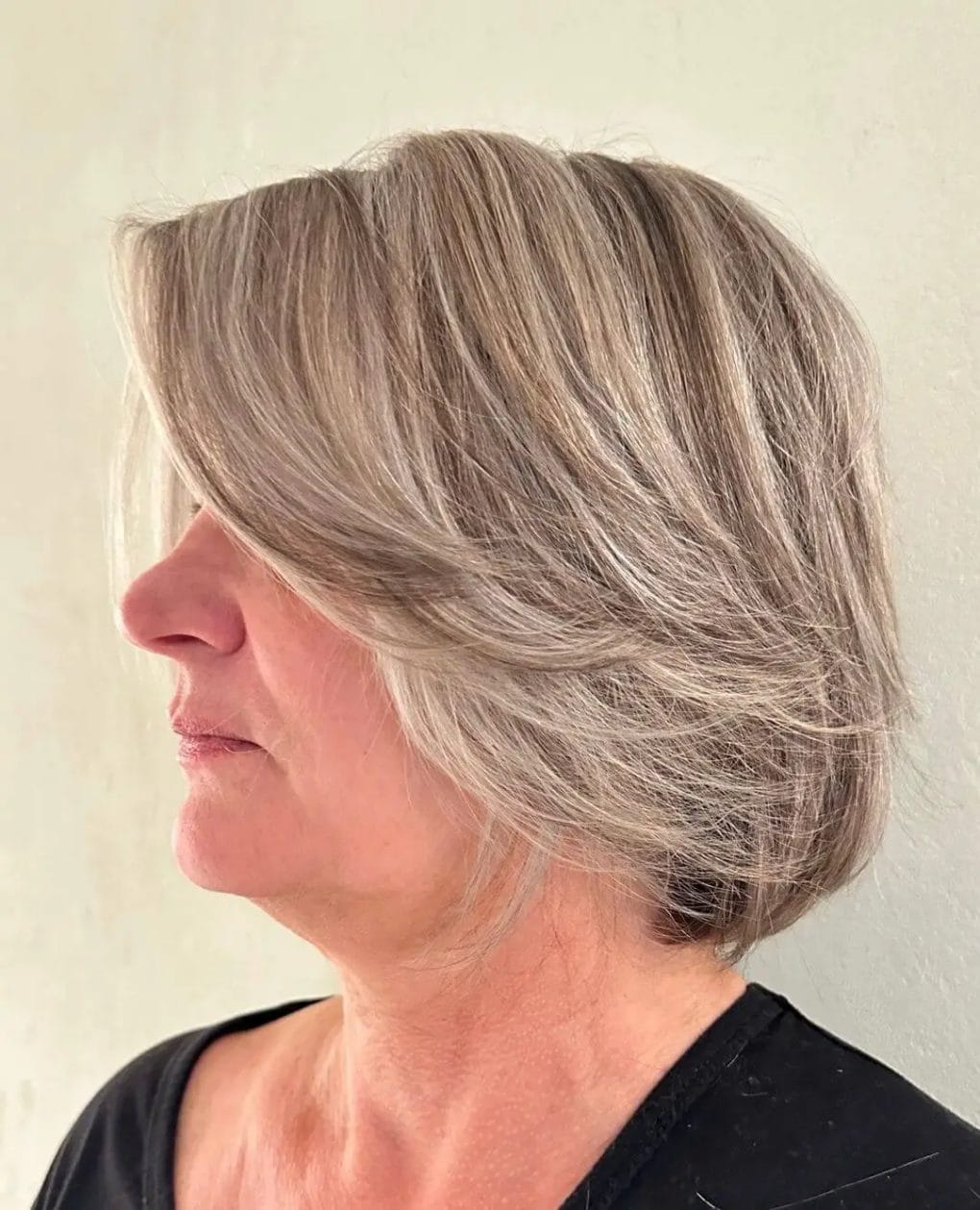 Graceful angled bob with volume-enhancing layers in grey and ash blonde.