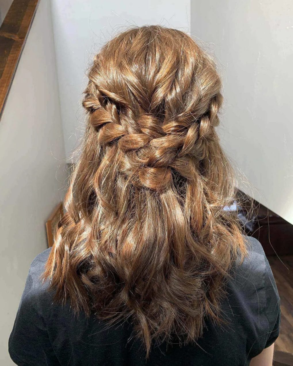 Chic half-up French braid blending into cascading chestnut waves.