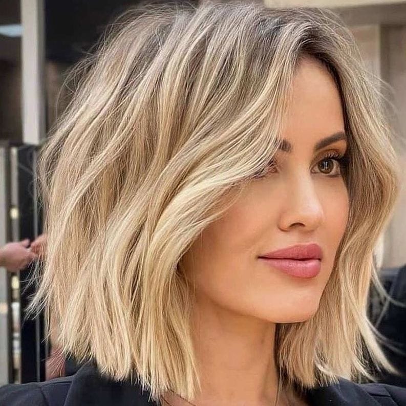 Layered bob, enhanced volume with light blonde balayage.
