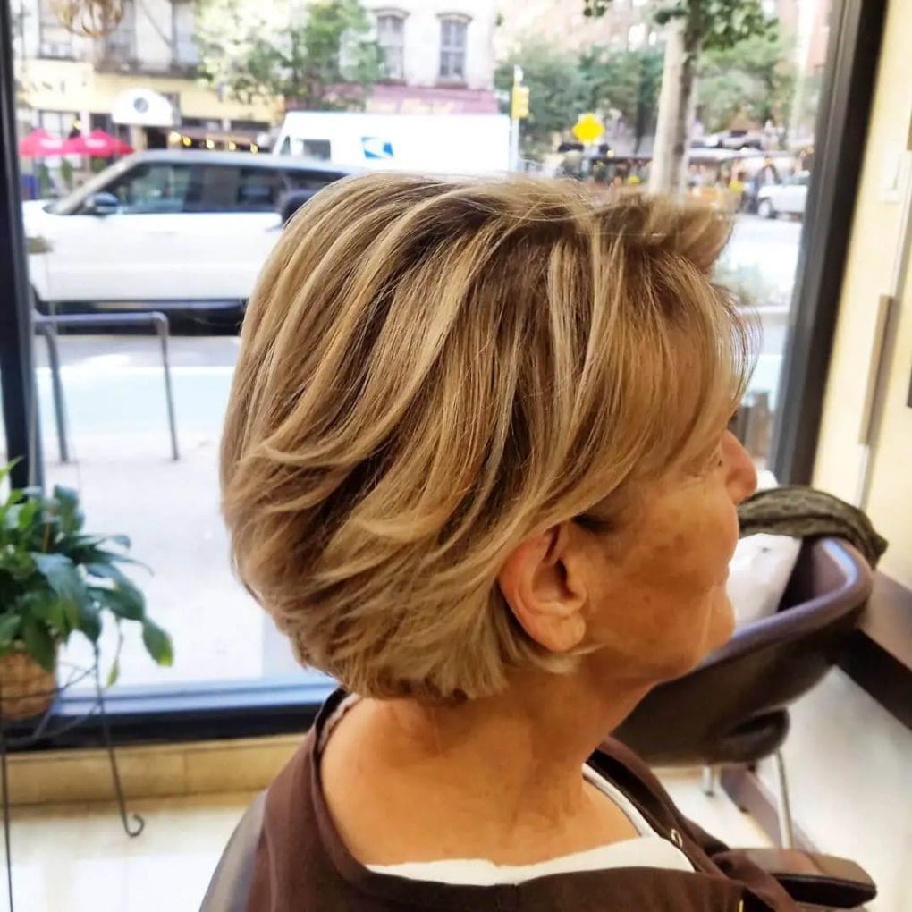 Chic layered pixie cut blending gray hair with youthful highlights.
