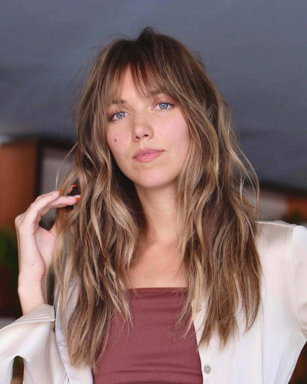 Honey and ash blonde waves with see-through bangs