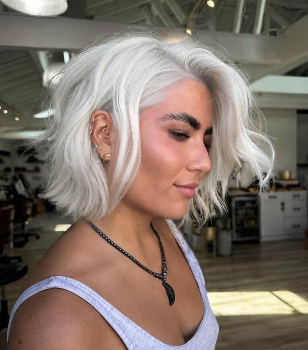 Platinum waves with a side part for thick hair.