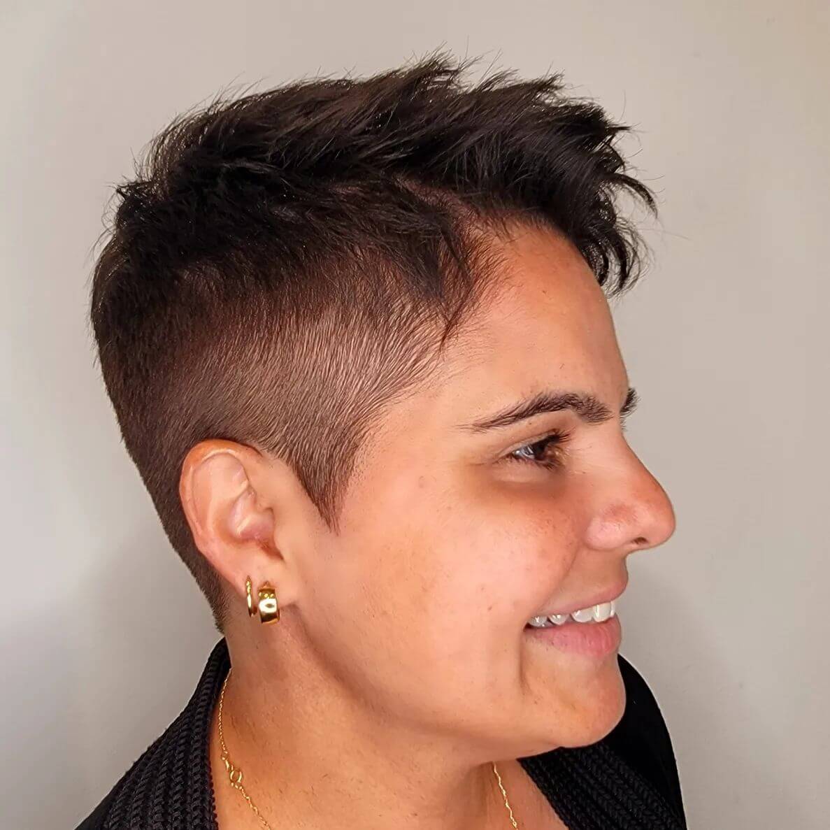 Multi-dimensional brunette pixie with elegant styling.