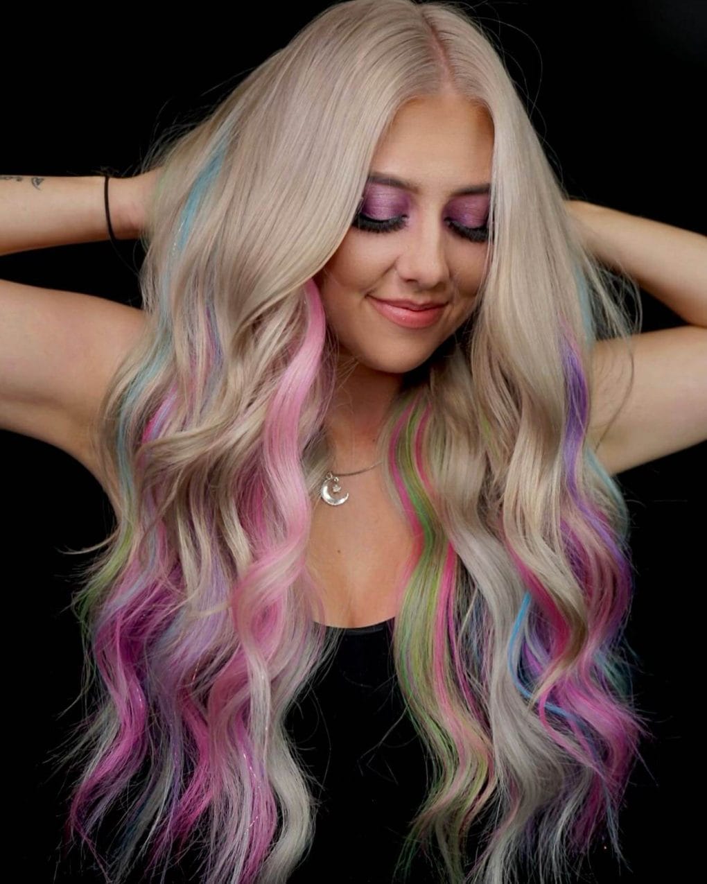 Whimsical pastel highlights in platinum blonde flowing waves.