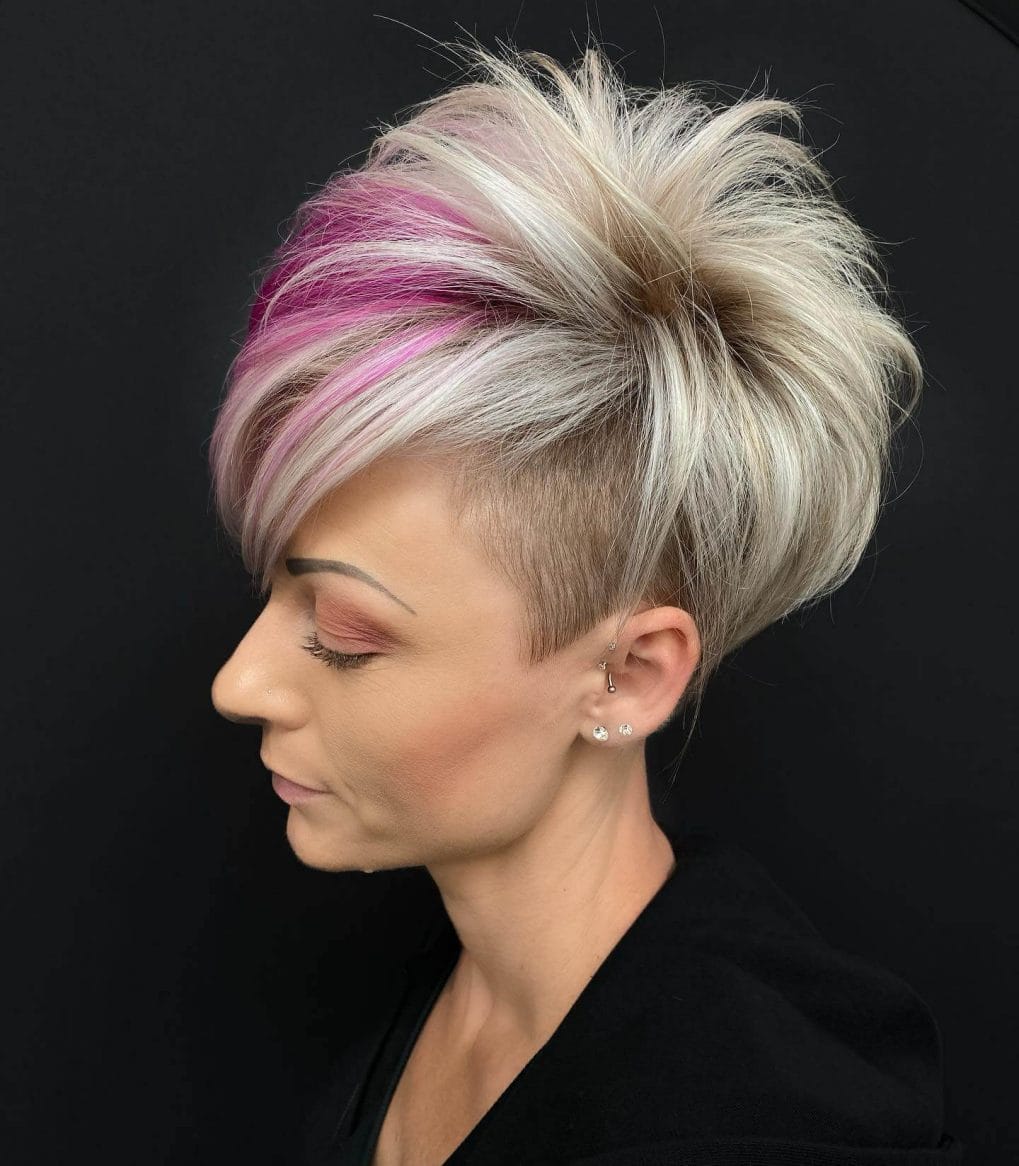 Bold platinum pixie with pink accent and voluminous top.