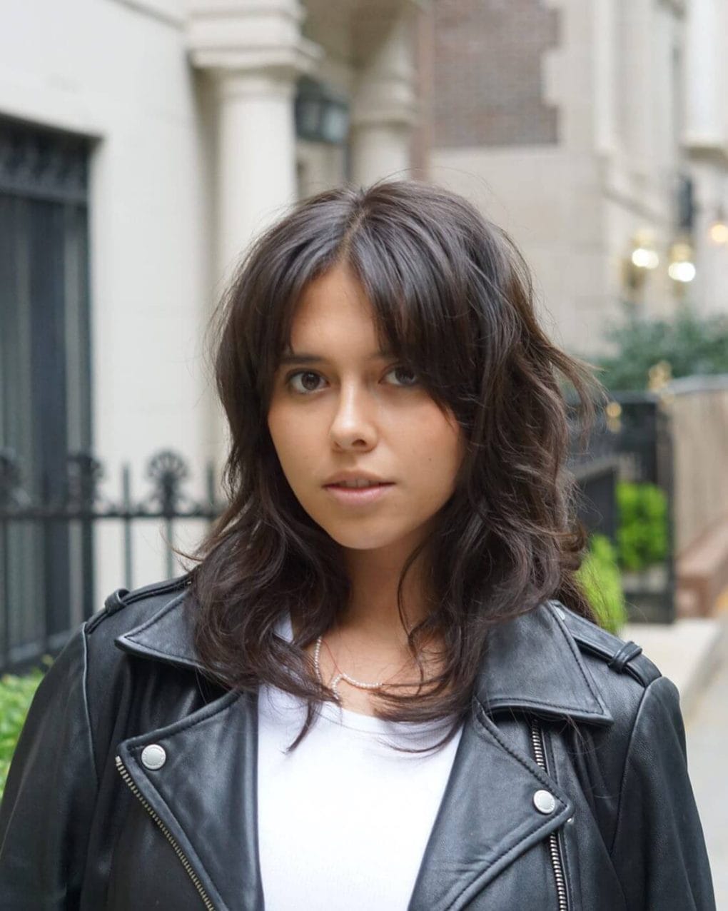 Playful chocolate brown wolf cut with wispy layers and curtain fringe.