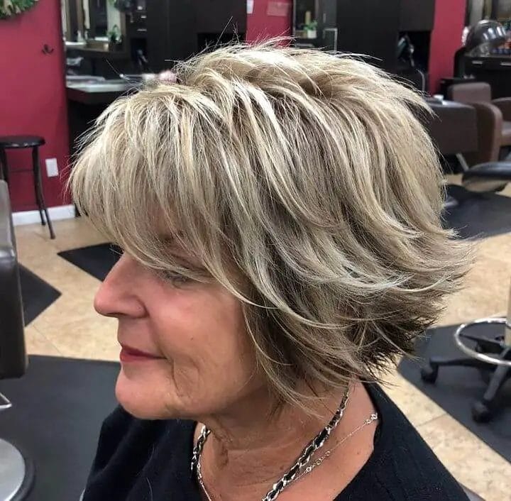 Short layered cut with playful texture and honey and platinum highlights.