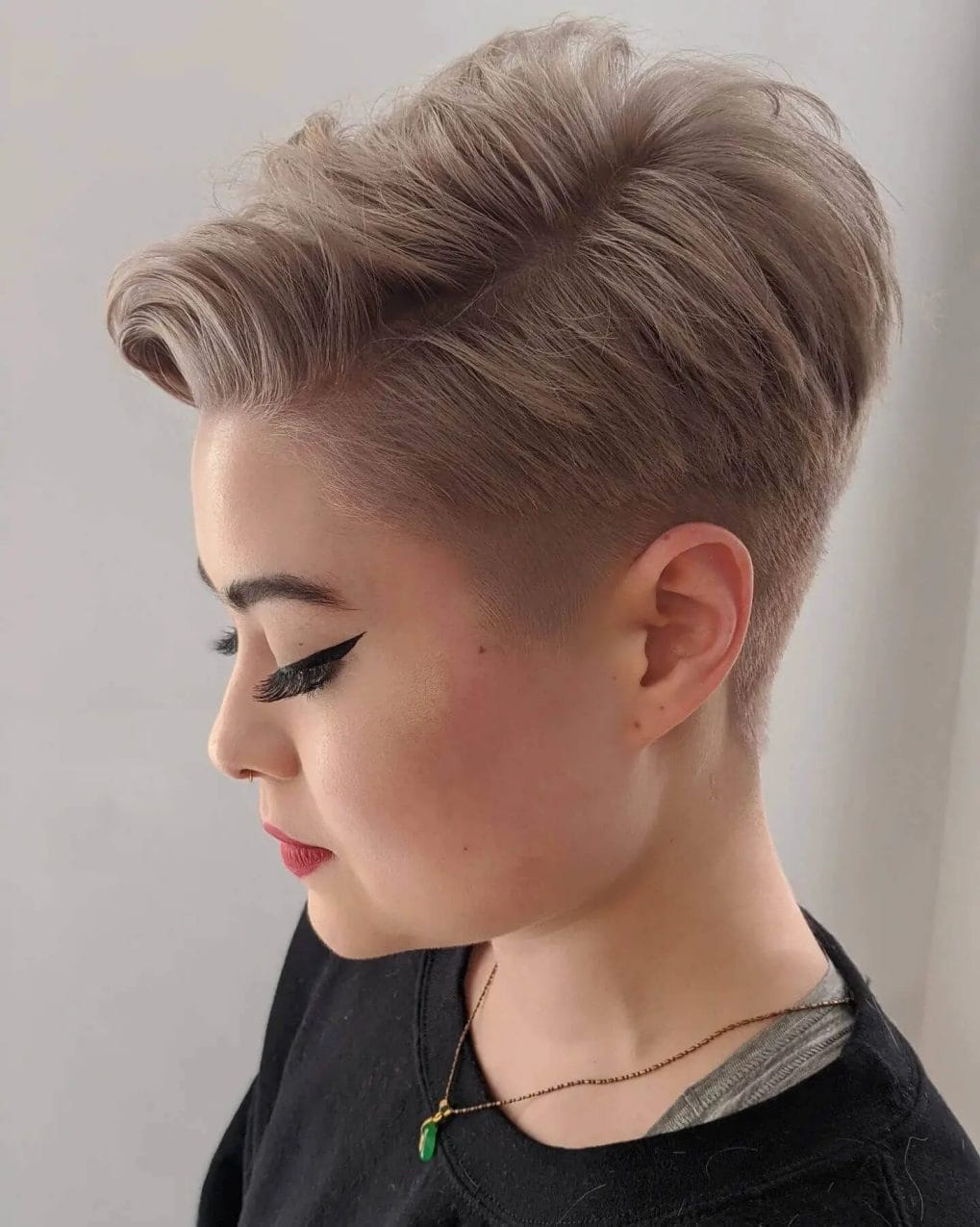 Icy bleach blonde pixie with a swept-back elegance.