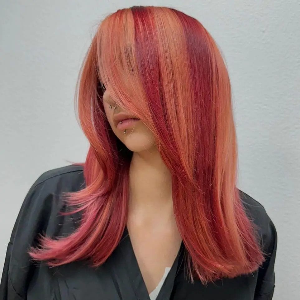 Fiery red and soft pink sunset blend in sleek straight cut.