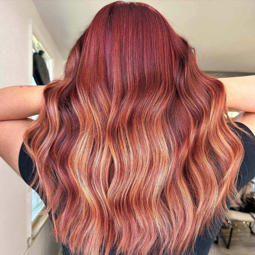 Deep ruby waves transitioning into peachy blonde ends.