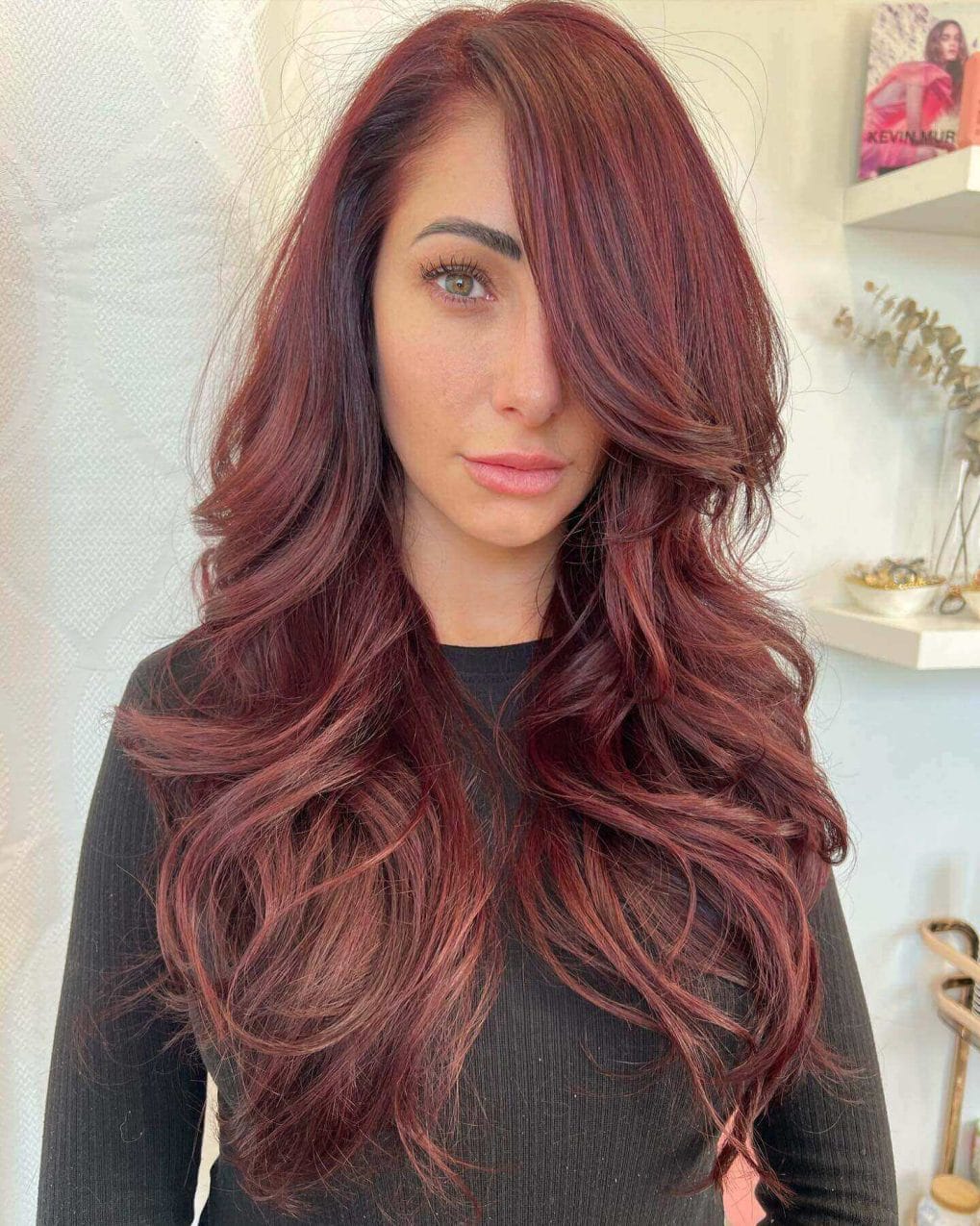 Red balayage with ruby shades on luxurious layers.