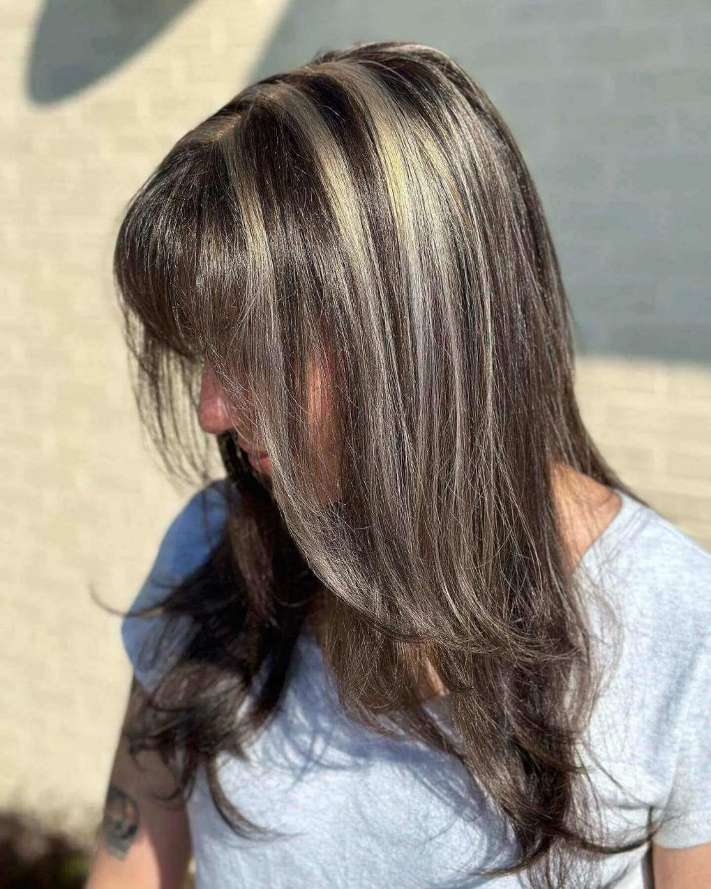 Layered haircut with honey blonde highlights and a natural gray blend
