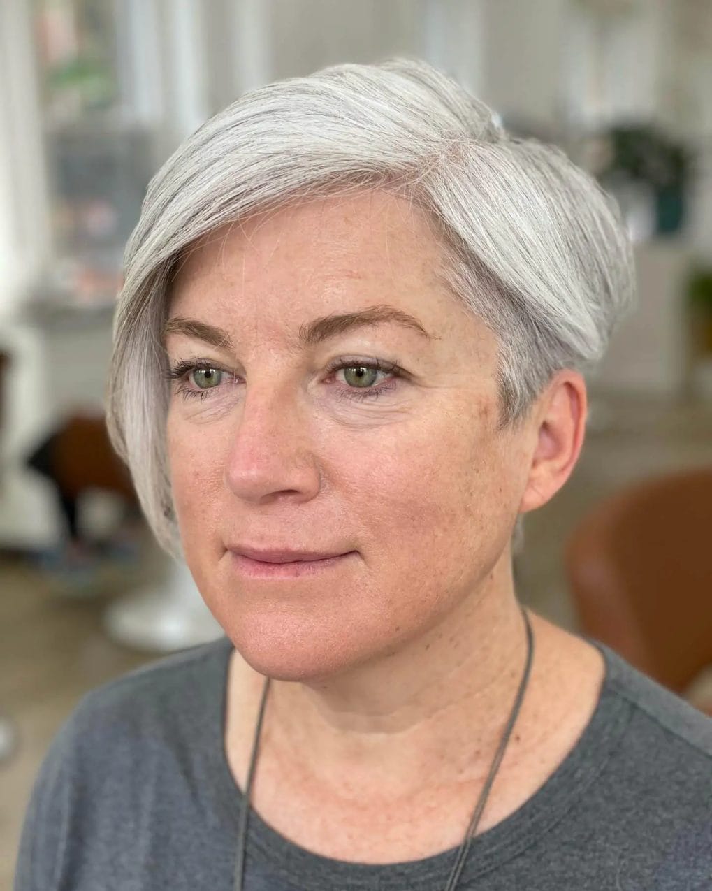 Sleek silver pixie with textured layers and side fringe.