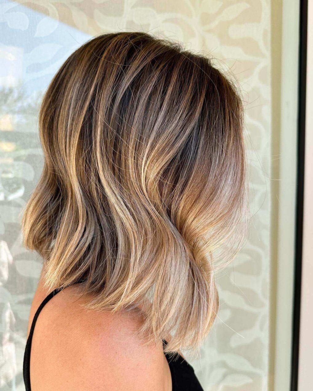 Graduated bob, feminine front layers, warm balayage blend.