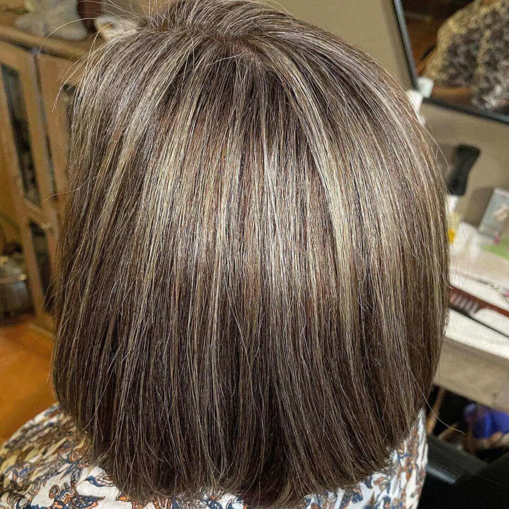 Sleek bob with subtle gray-blending thin highlights and elegant layers.