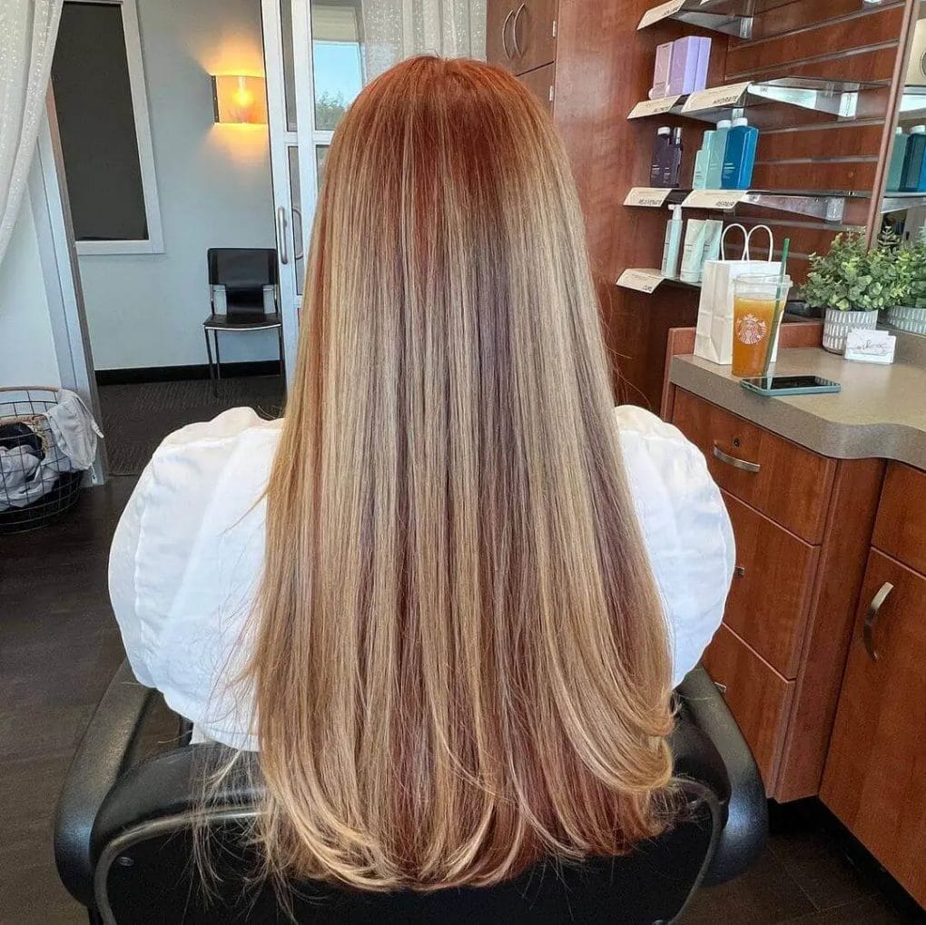 Sleek and straight hair with seamless red to blonde balayage.