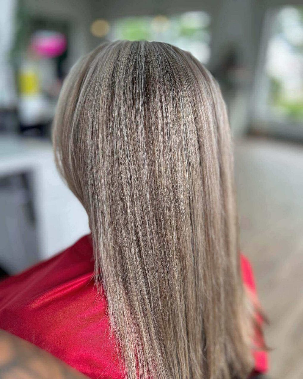 Sleek, straight hair with lustrous silvery and ash blonde highlights.