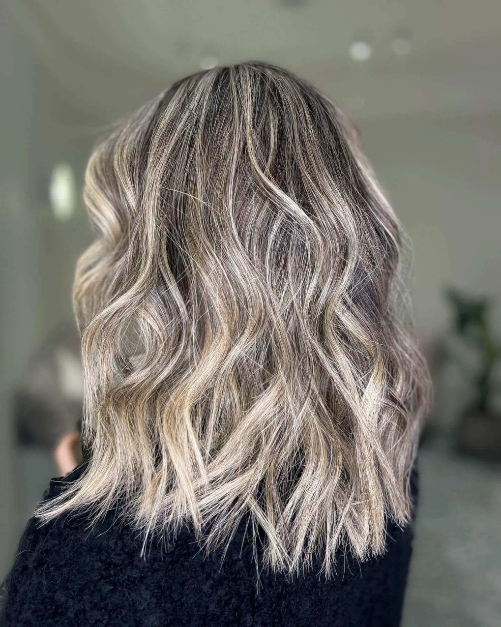 Layered hairstyle, full-bodied with beachy balayage.