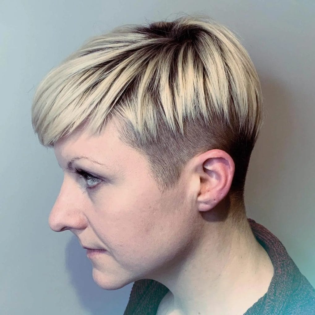 Undercut pixie with blonde top and dark roots.