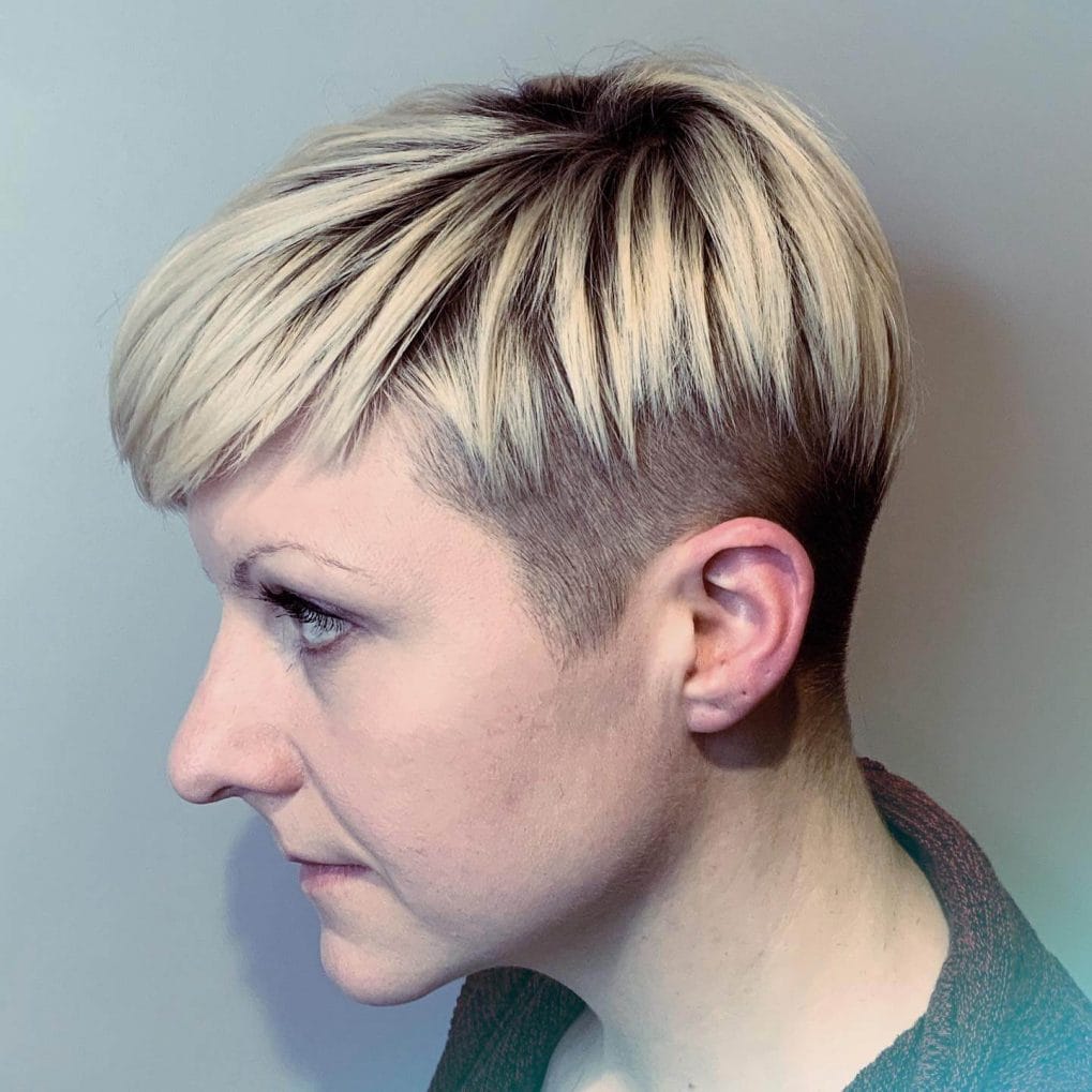Undercut pixie with blonde top and dark roots.