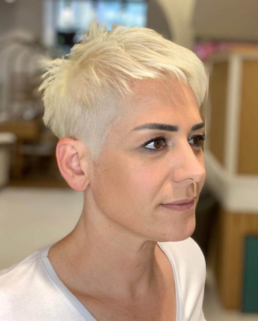 Textured platinum undercut pixie with playful top.