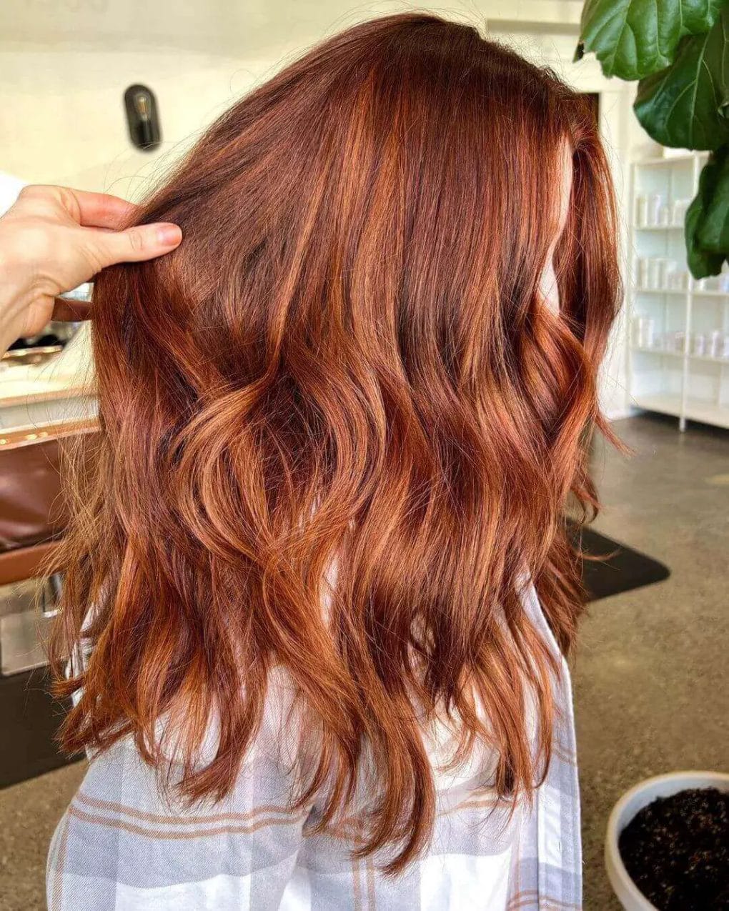 Dimensional red balayage with sunset hues, layered waves.