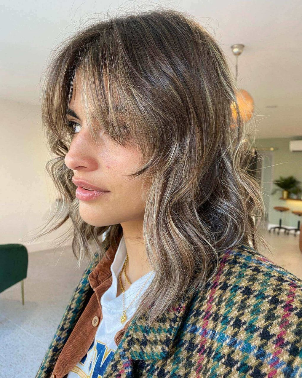 Sun-kissed balayage wolf cut with bouncy layers and playful fringe.