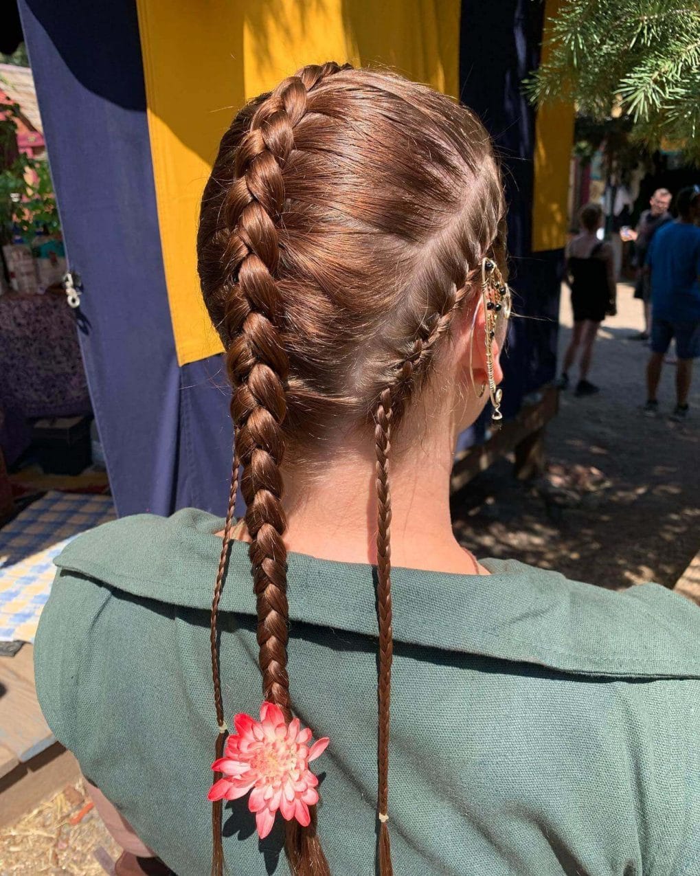 Symmetrical Viking braids in natural brunette and auburn shades.