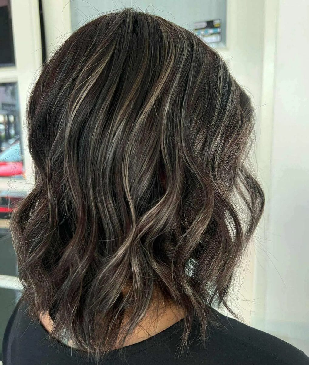 Textured bob with precision-cut layers blending gray hair.
