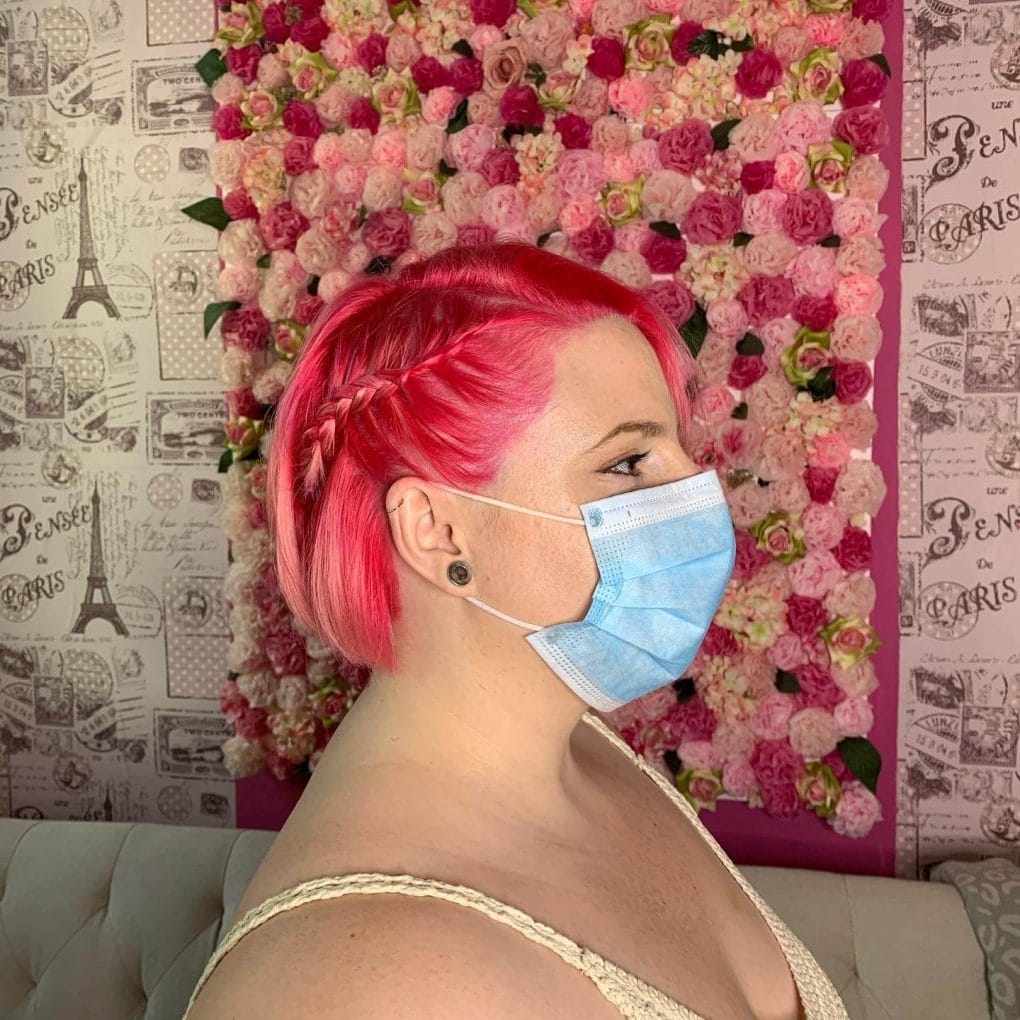 Pink bob with whimsical side braid.