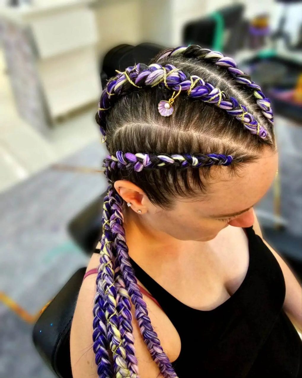 Vibrant Viking braids in purple with golden charms.