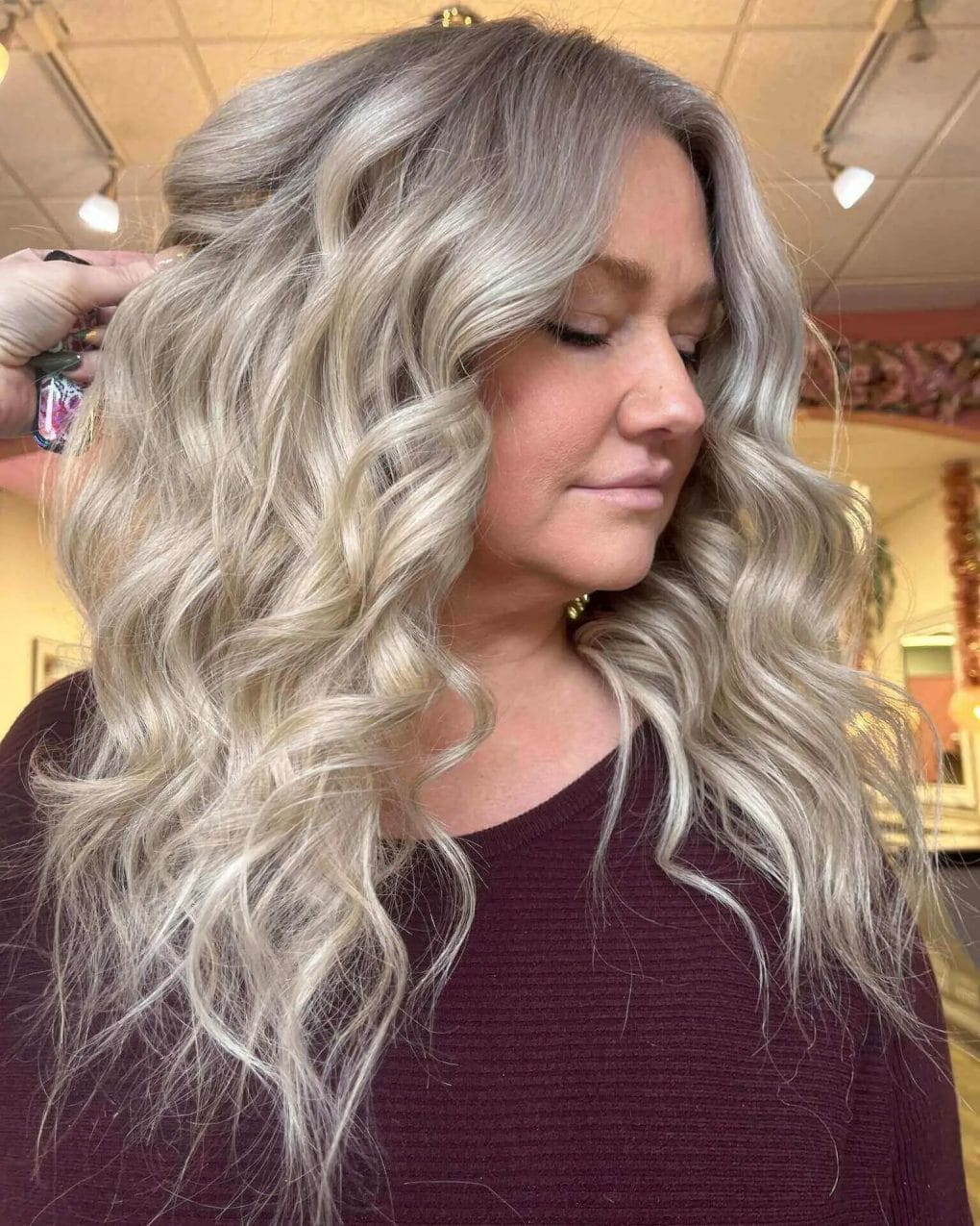 Luxurious, voluminous curls and layers with ash and platinum highlights.