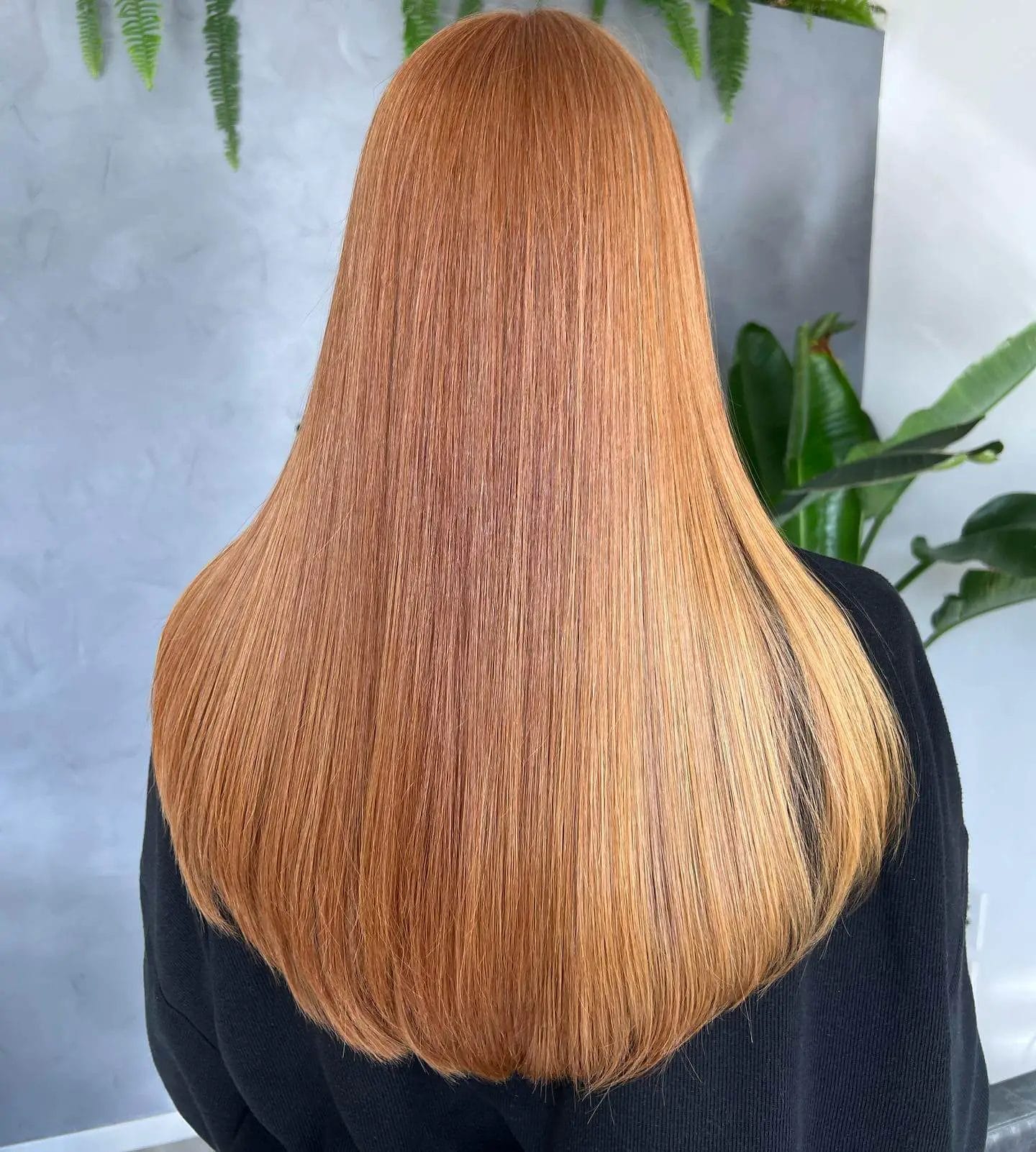 Amber radiant U-shaped haircut transitioning from copper roots to golden honey tips.
