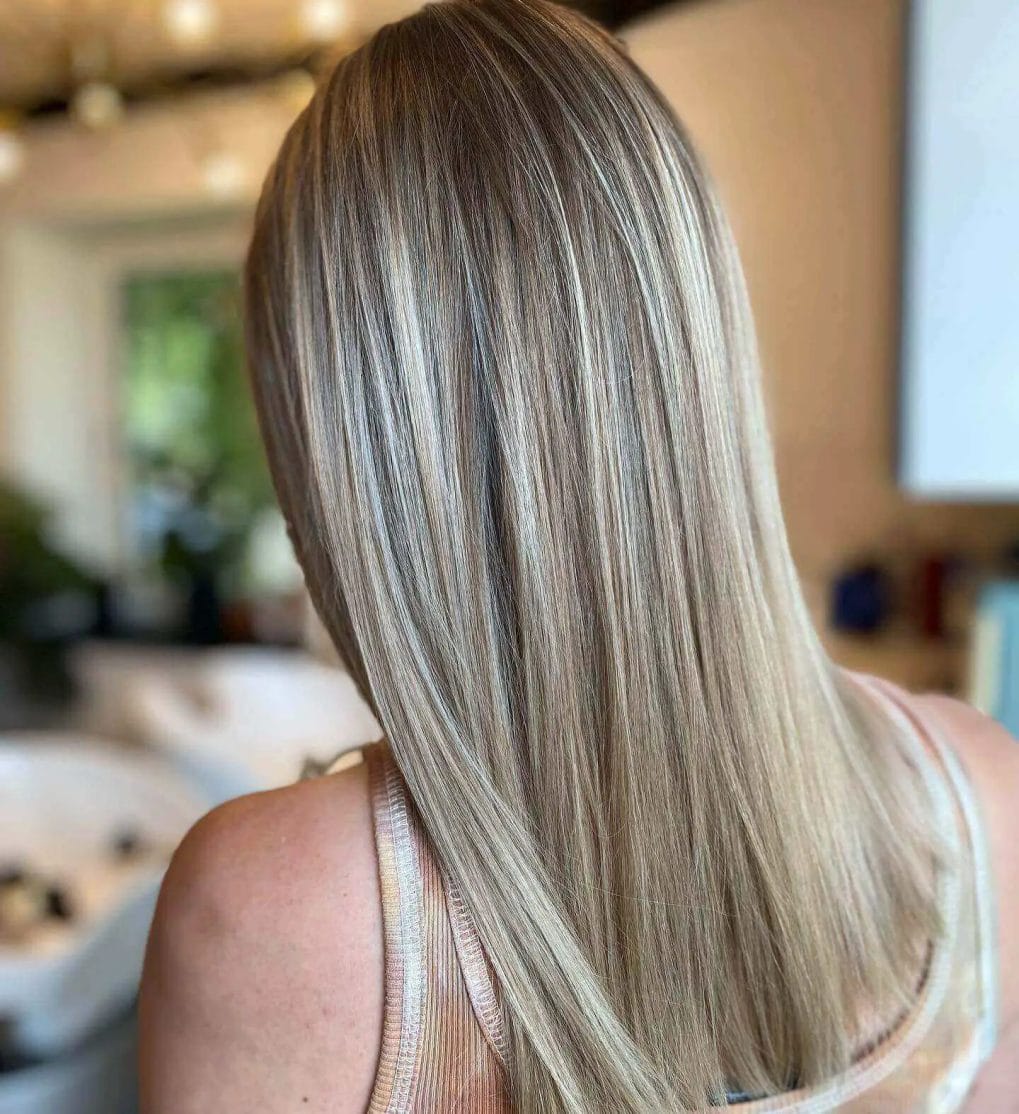 Straight hair with balayage from dark ash blonde roots to beige blonde ends.