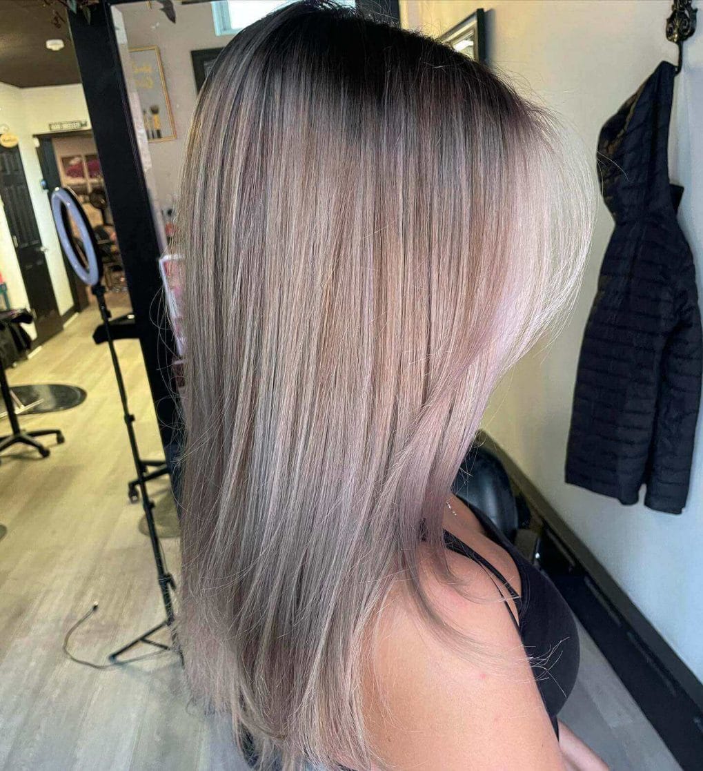 Straight long bob with cool ash-blonde balayage and natural root shadow.