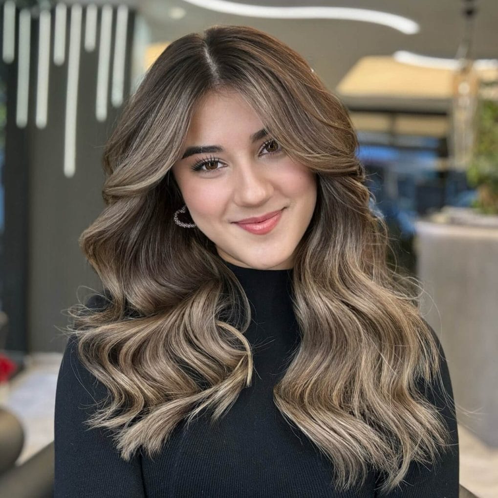 Ash and honey balayage waves with long, sweeping bangs