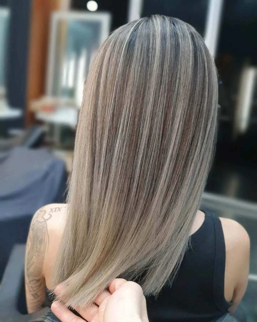 Shoulder-length straight hair featuring ash and platinum blonde highlights on darker base.