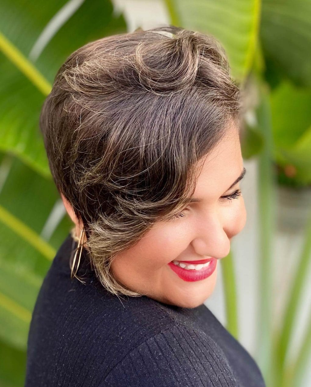 Gold-highlighted wavy pixie with a unique asymmetrical sideburn.