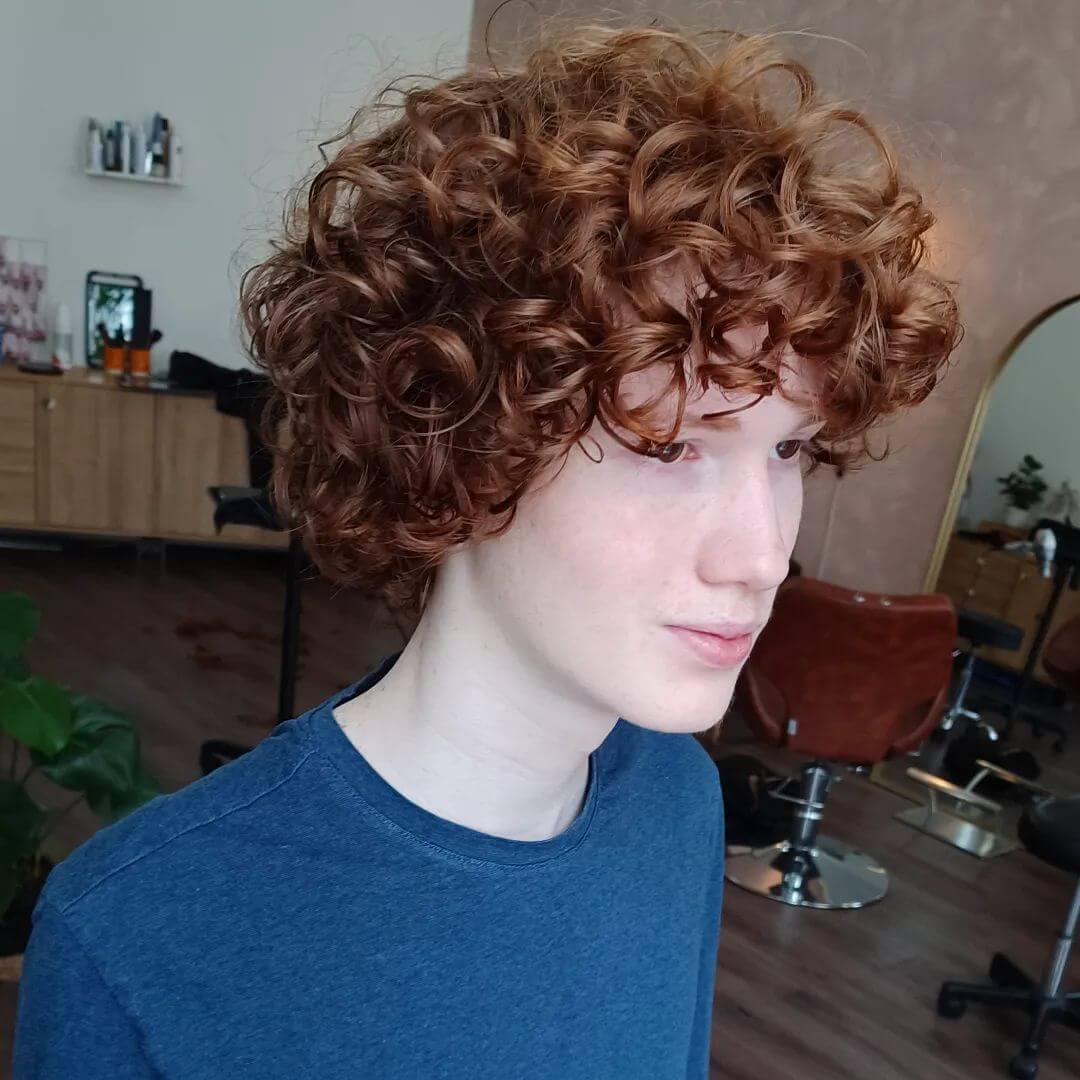 Auburn bob with face-framing ringlets for a lively look.