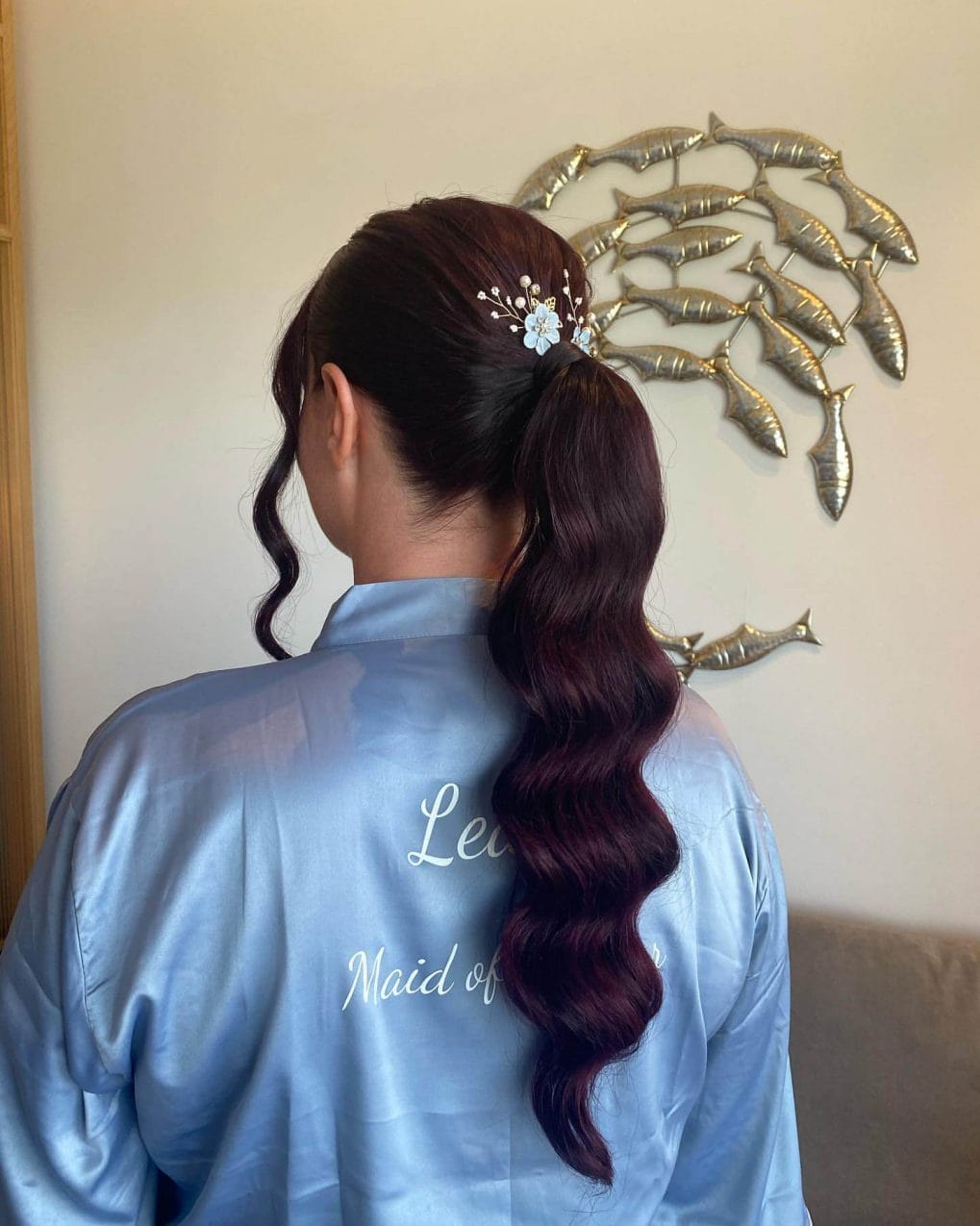 Auburn ponytail with loose flowing waves.