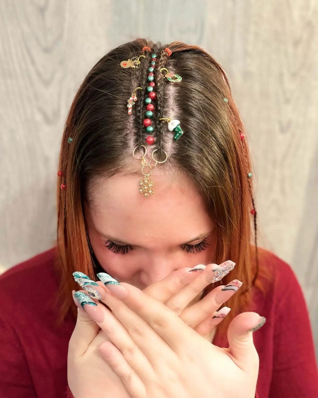 Warm auburn straight cut with tiny braids decorated with vibrant beads and charms.
