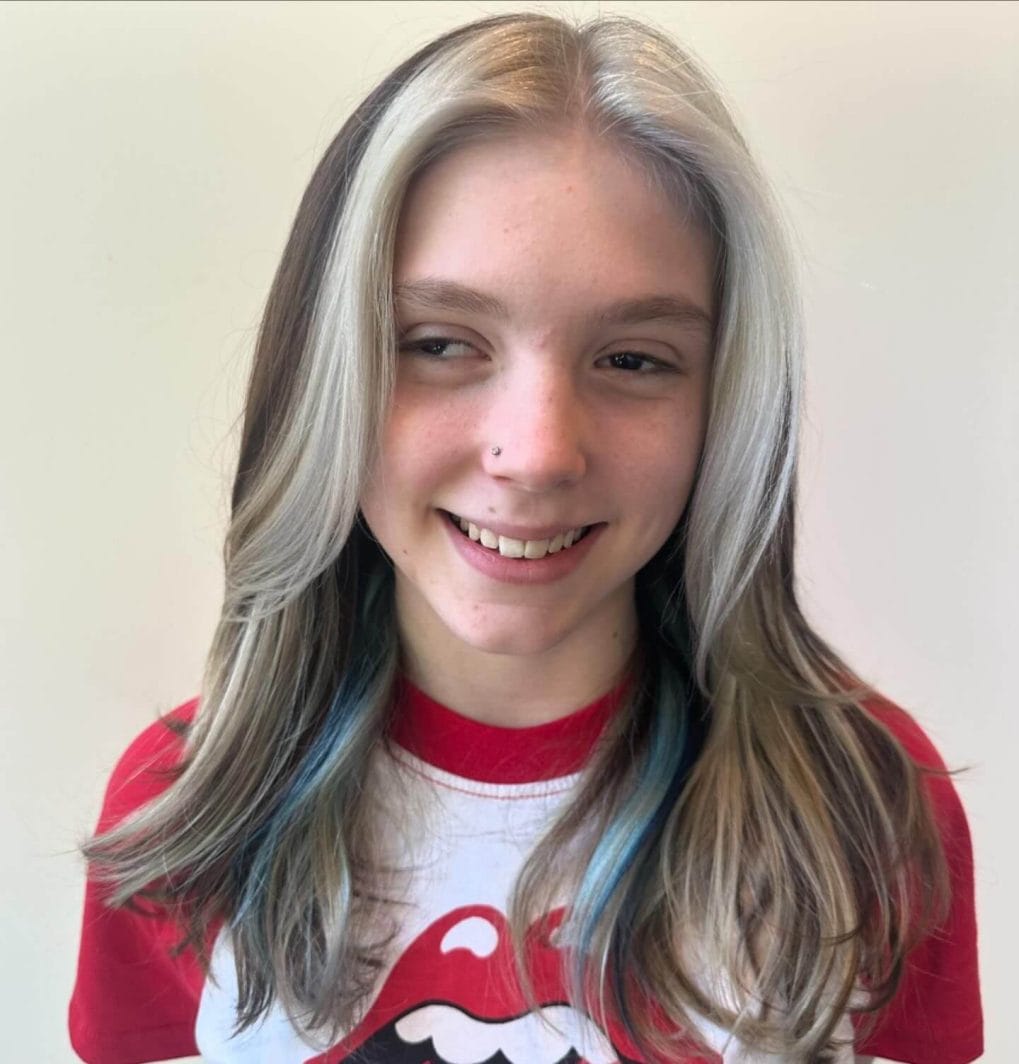 Long straight hair with bold white highlights and dark roots for school