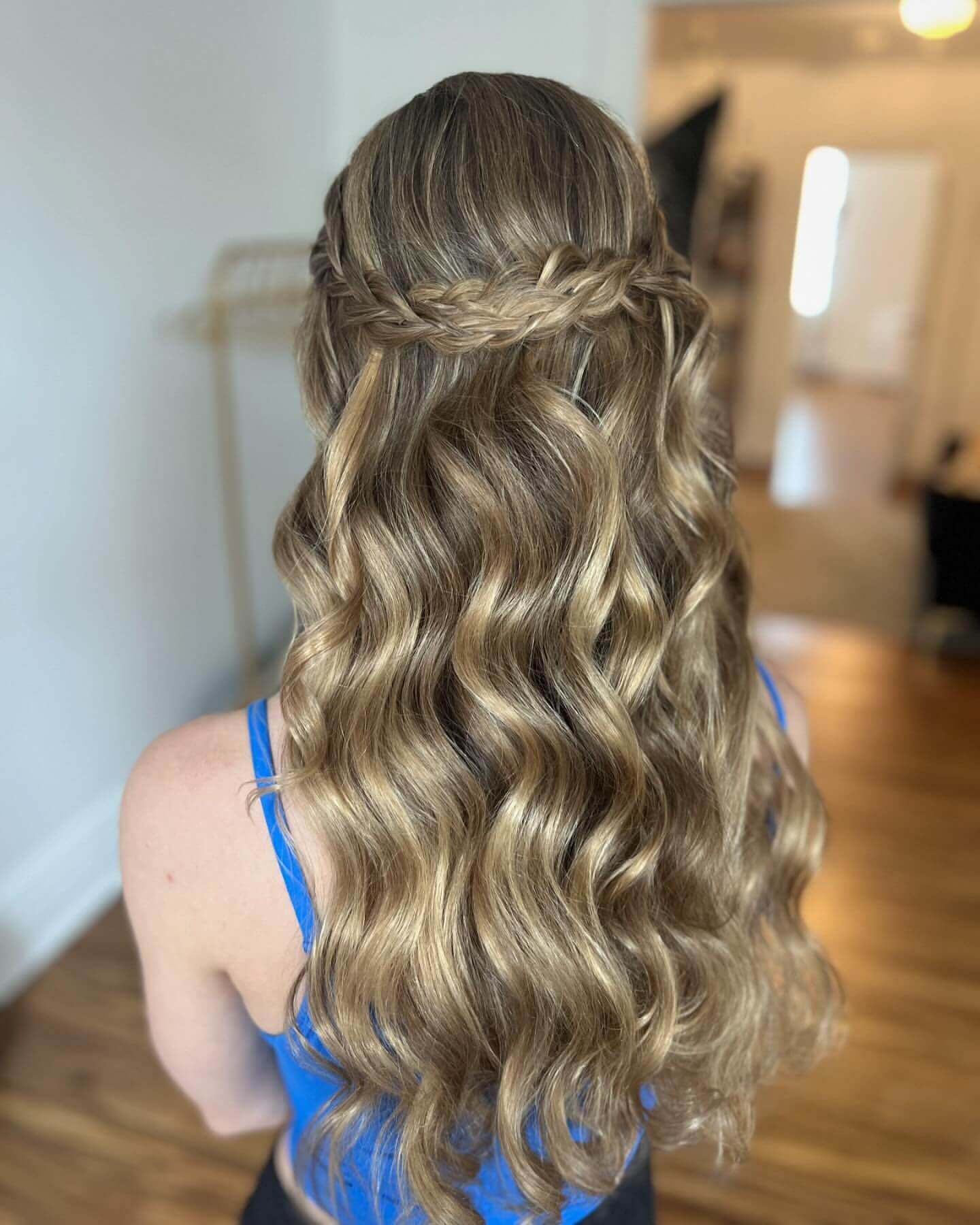 Long wavy hair with a delicate crown braid for a school event