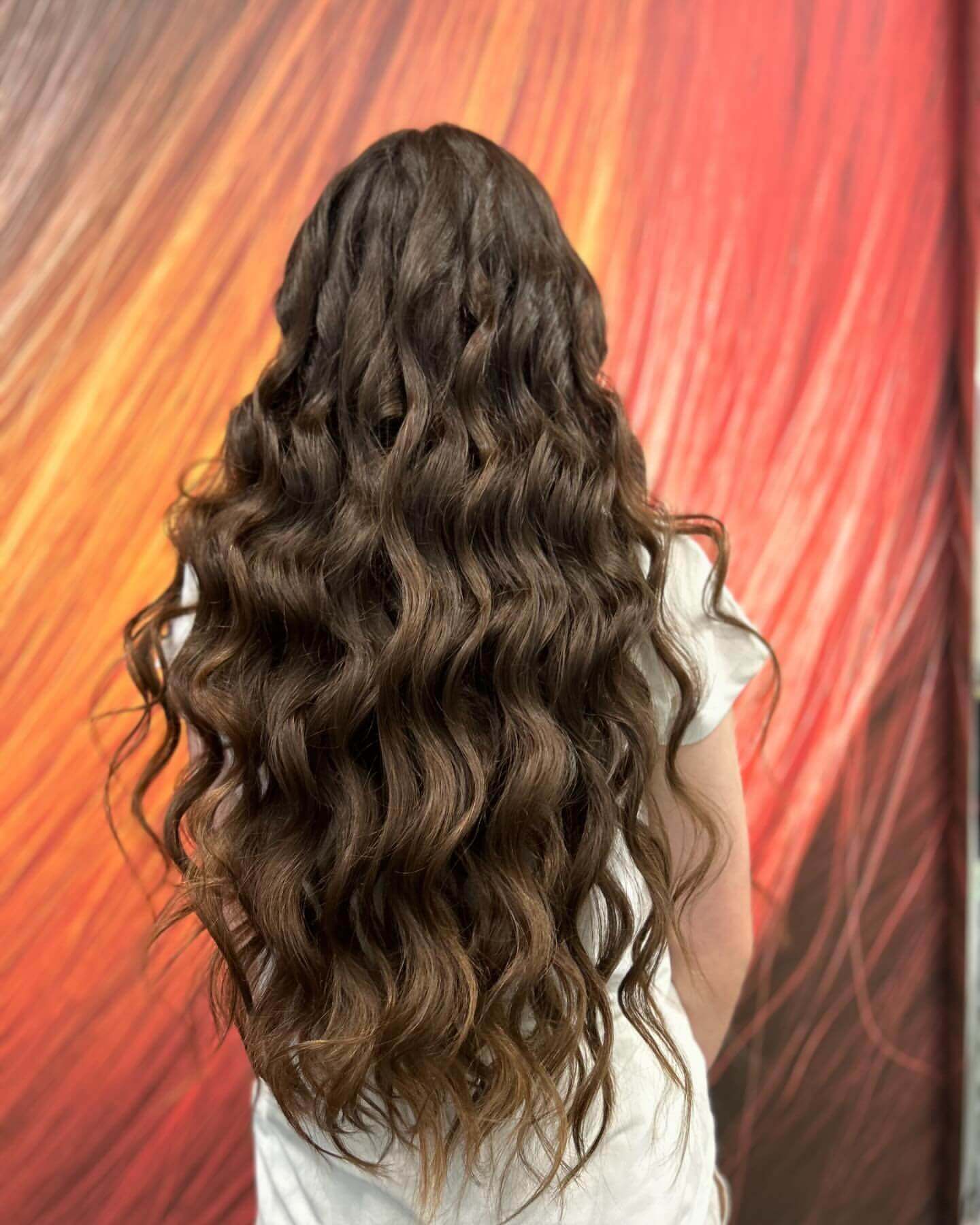 Long thick hair with deep defined waves and rich dark brown color for school