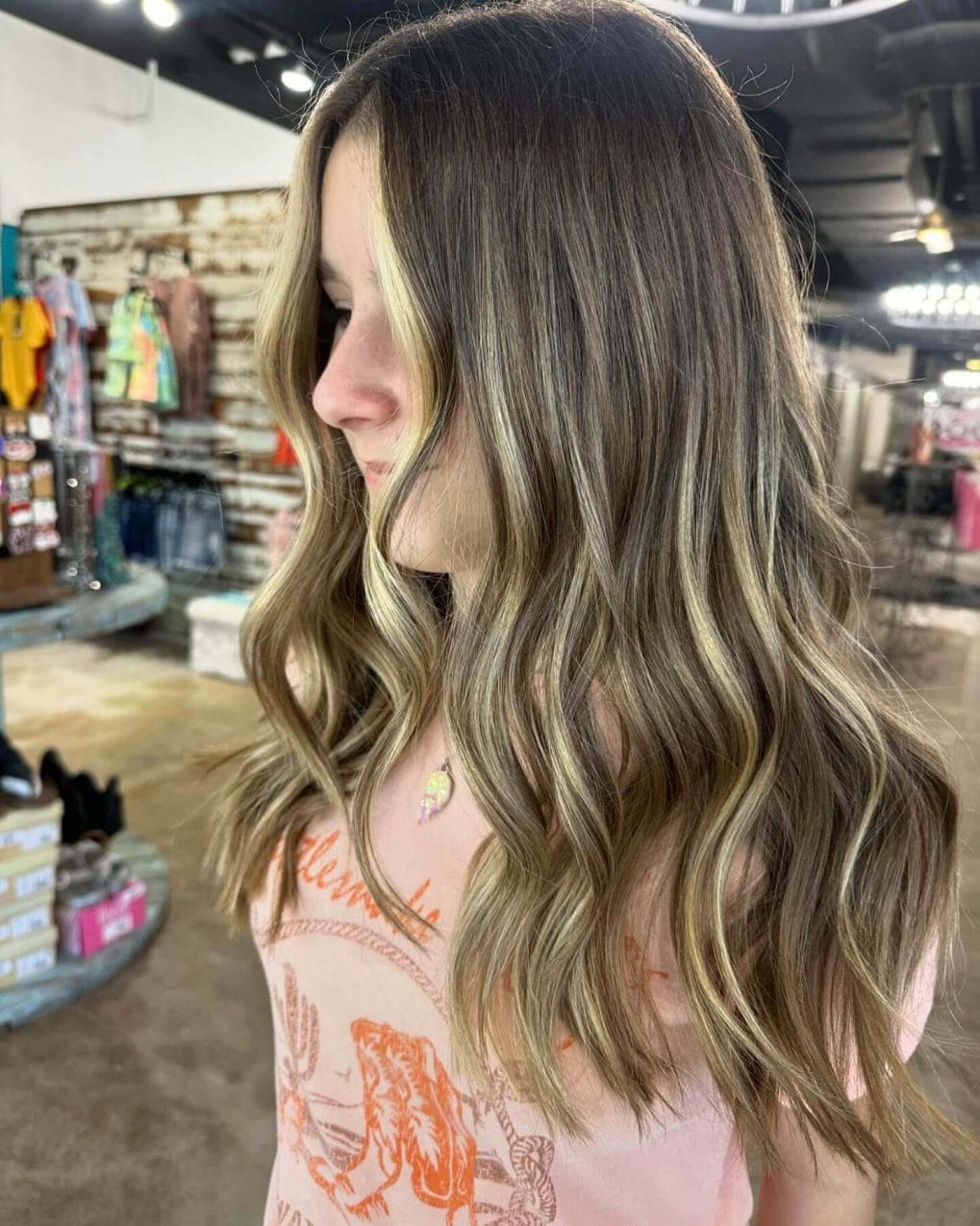 Long soft waves with subtle highlights and a middle part for school