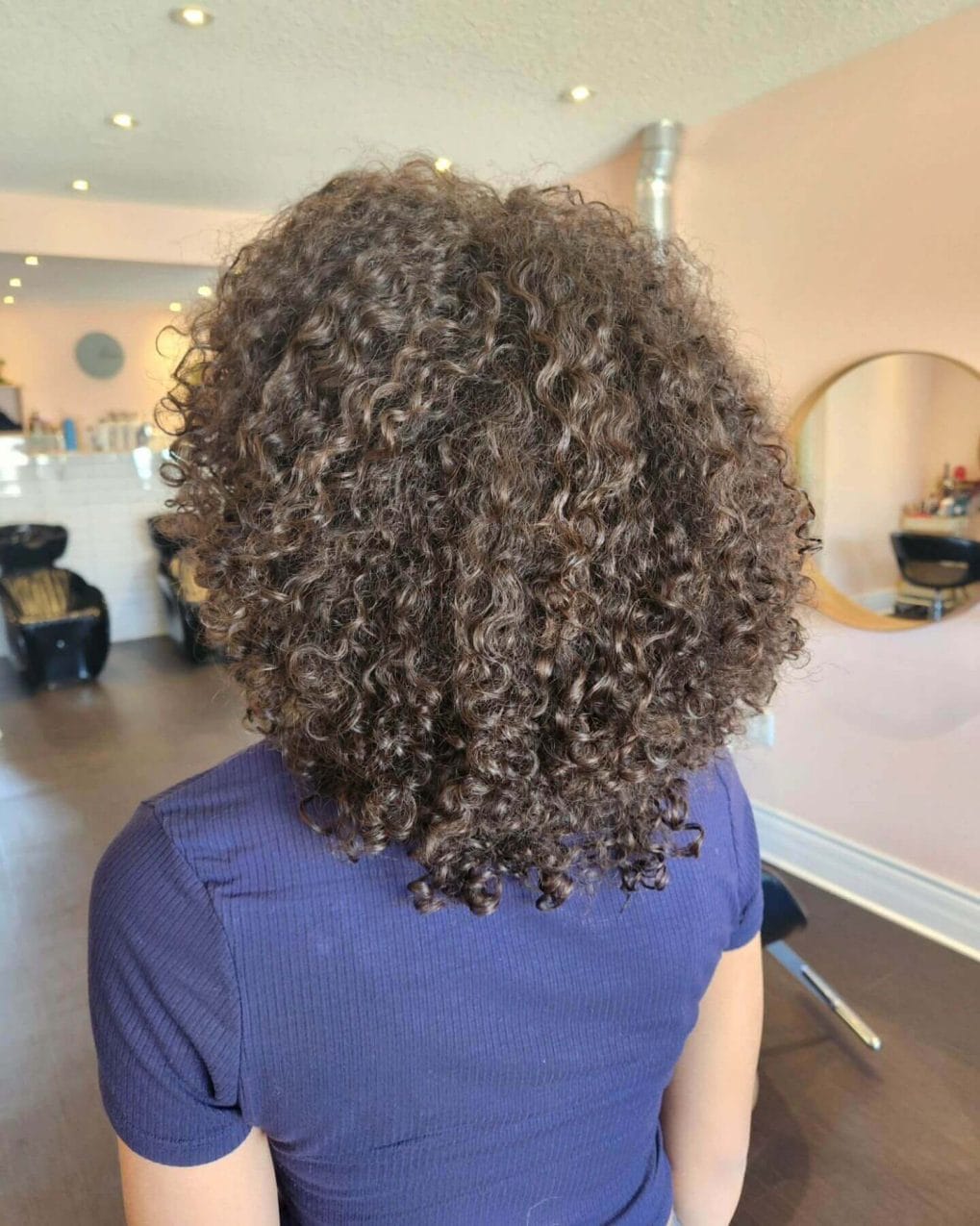 Short to medium naturally curly hair with volume and bounce for school